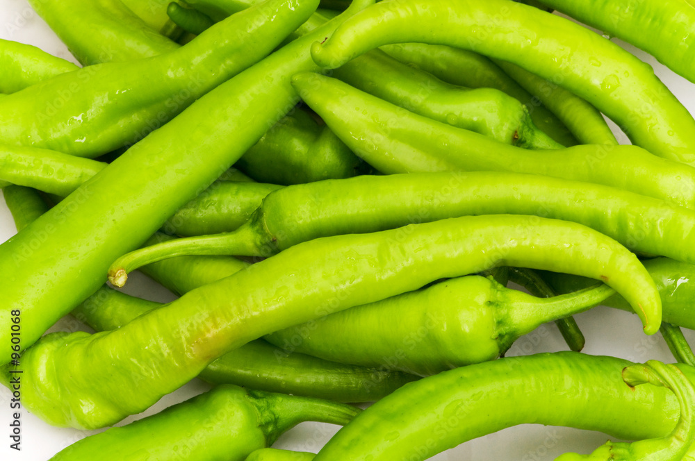 Green peppers in the plate isolated on white Green peppers in the plate isolated on white