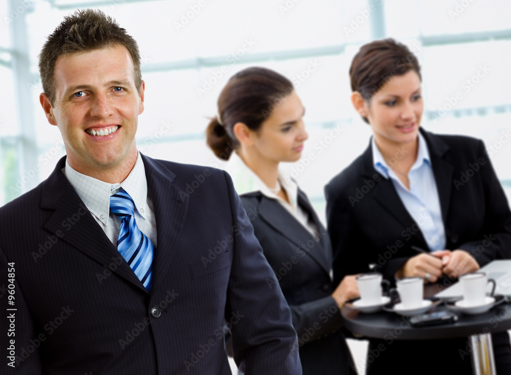 Happy successful business team working smiling at office. Happy successful business team working smiling at office.