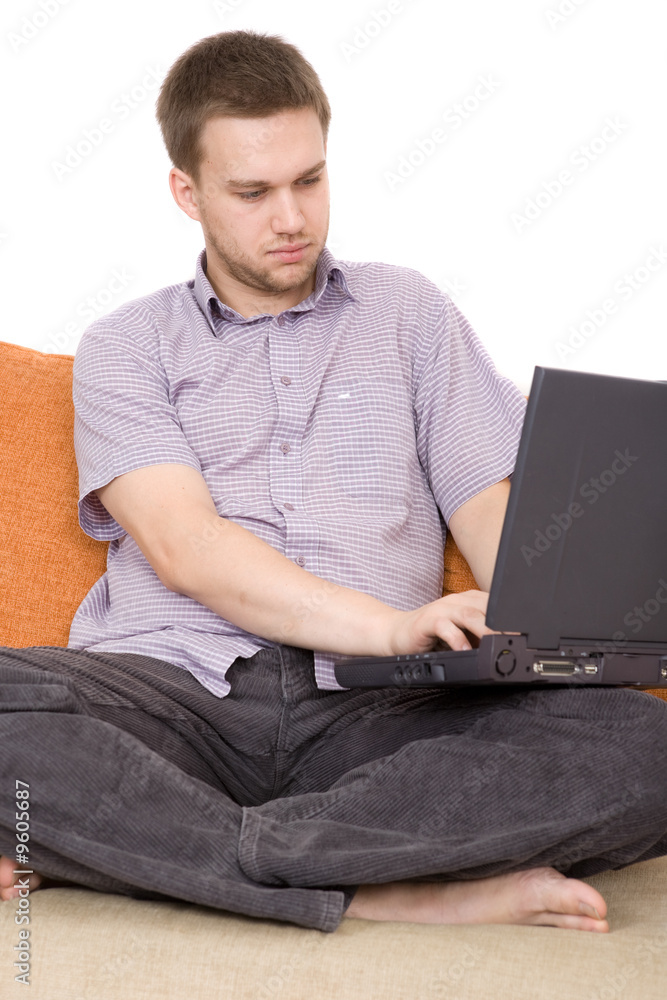 casual guy sitting on sofa with laptop casual guy sitting on sofa with laptop