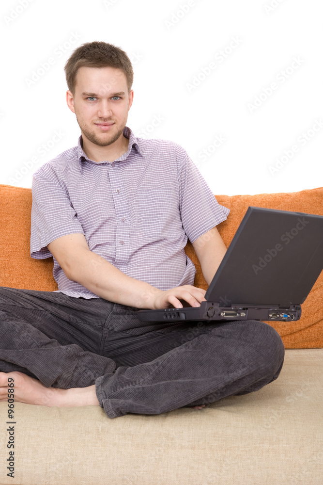 casual guy sitting on sofa with laptop casual guy sitting on sofa with laptop