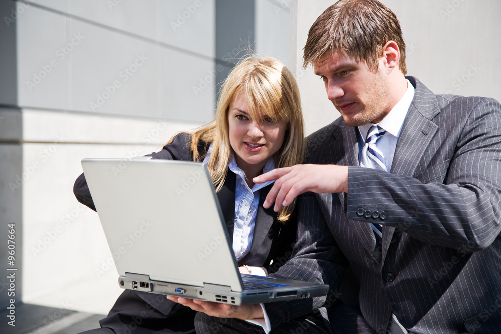 Two working caucasian business people having a discussion Two working caucasian business people having a discussion