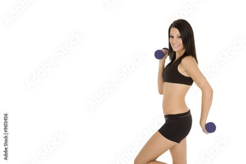 Beautiful Caucasian woman working out with dumbbells