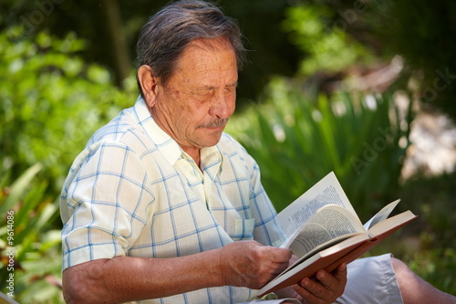 Healthy looking old man is his late 70s sitting in garden