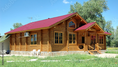 Porch of the big wooden house combined from logs.