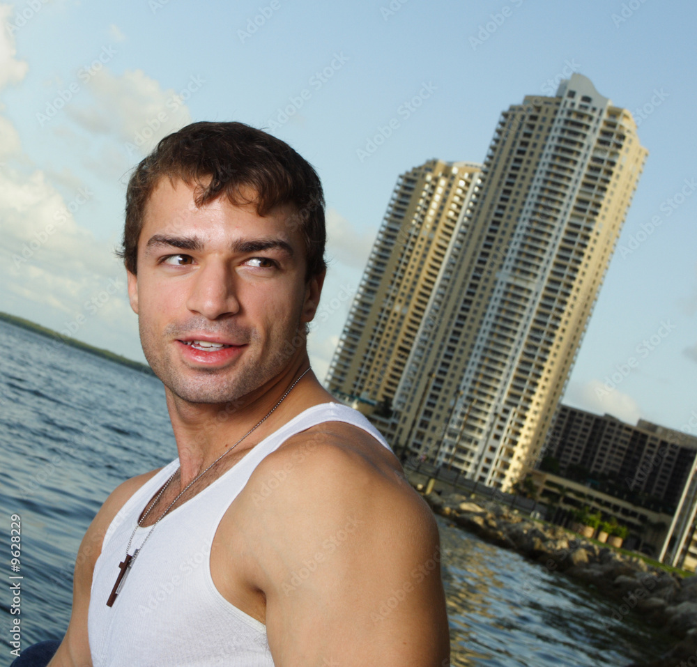 Man with waterfront buildings in the background