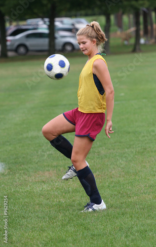 Youth Teen Soccer Player Bouncing Ball in Air