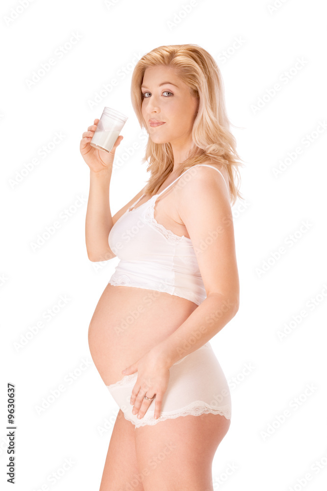 Pregnant blonde woman in white with glass of milk Pregnant blonde woman in white with glass of milk