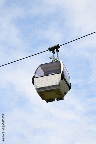 Cable car cabin against cloudy sky