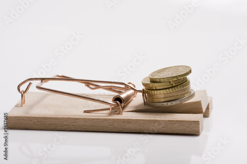 Maustrap with money as the bait. Isolated on white. Studio shot.
