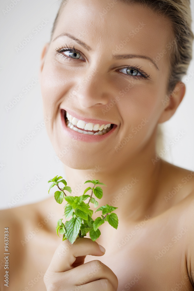 woman holding peppermint sprig woman holding peppermint sprig