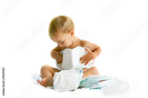 Bild auf Leinwand baby playing with diapers over white