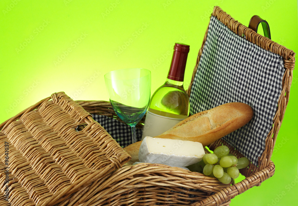 closeup on picnic basket filled with food and wine closeup on picnic basket filled with food and wine