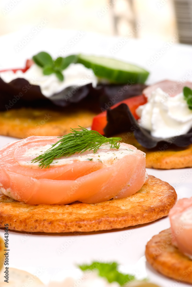 cracker with salmon cream cheese spread and olive