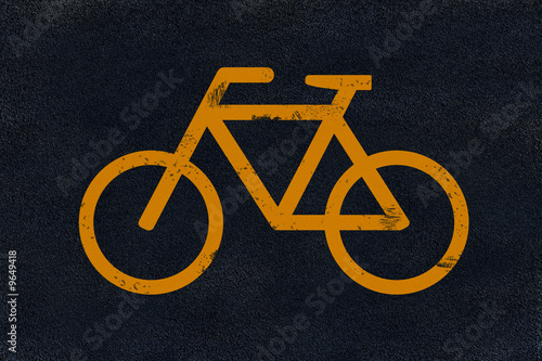 Yellow bicycle marking on black fresh asphalt pavement