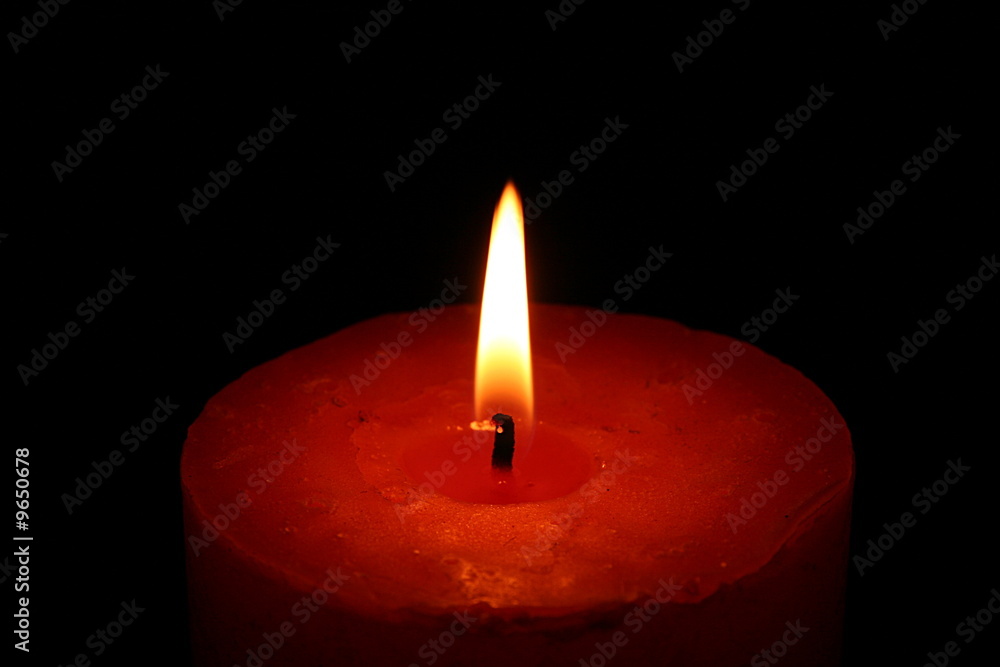 Close up of a candle with black background Close up of a candle with black background