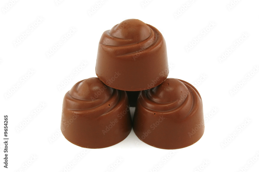 Pyramid from chocolate candies on a white background Pyramid from chocolate candies on a white background
