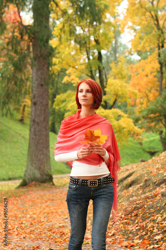 young girl walking in autumn park