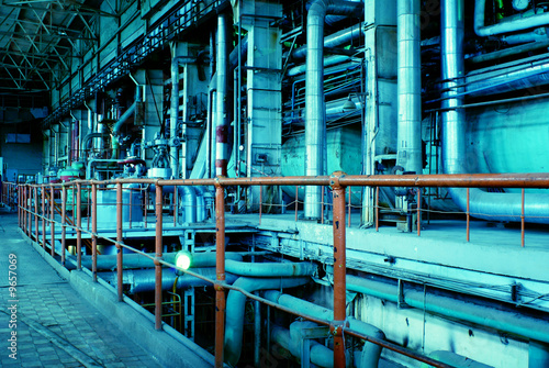 Equipment, cables and piping inside of a industrial power plant photo