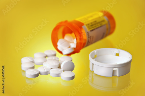 Spilled Prescription Medication w/ Orange Pill Bottle On Yellow