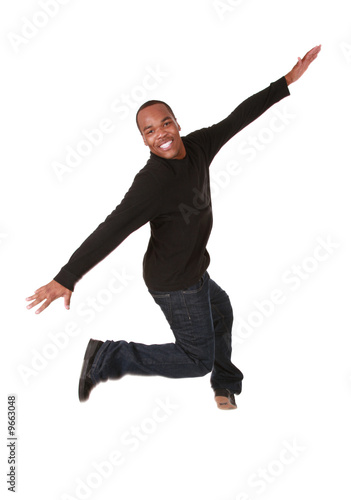 Young man jumping of joy on pure white background