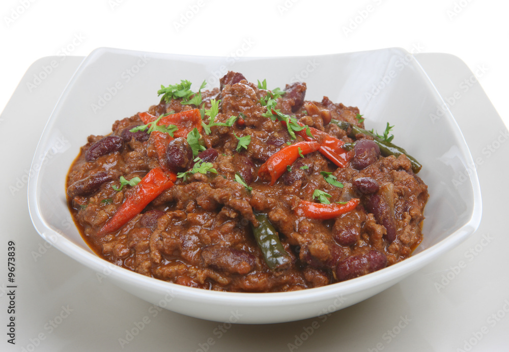 A bowl of hot chilli con carne with bird's eye peppers A bowl of hot chilli con carne with bird's eye peppers