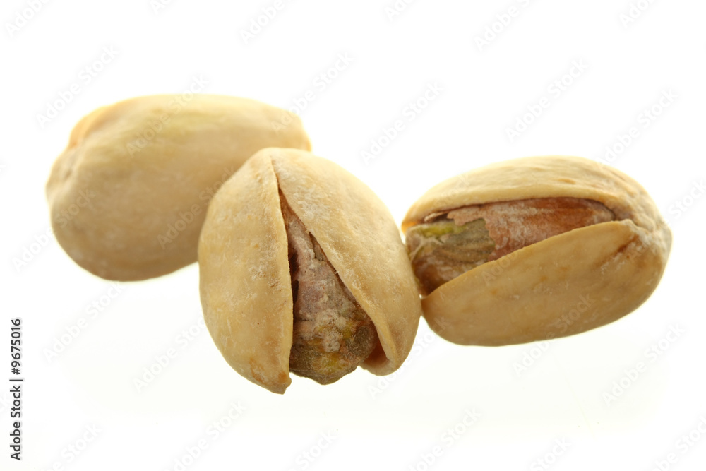 Fototapeta premium Three Pistachios Isolated Against White