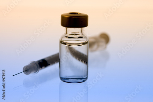 vial of clear liquid with syringe photo