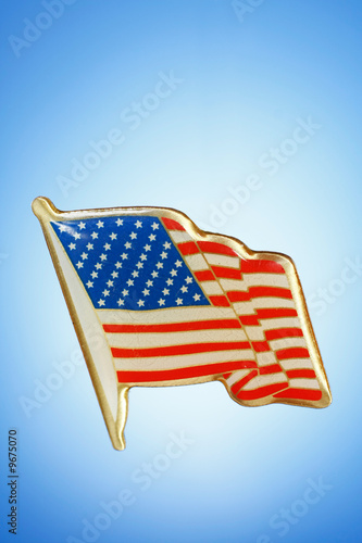 golden American Flag lapel pin on gradient background