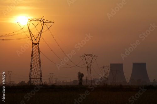 Power line of a nuclear power station; sunset.
