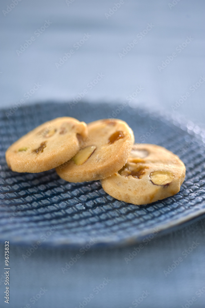 three homemade cookies on a blue ceramic plate three homemade cookies on a blue ceramic plate