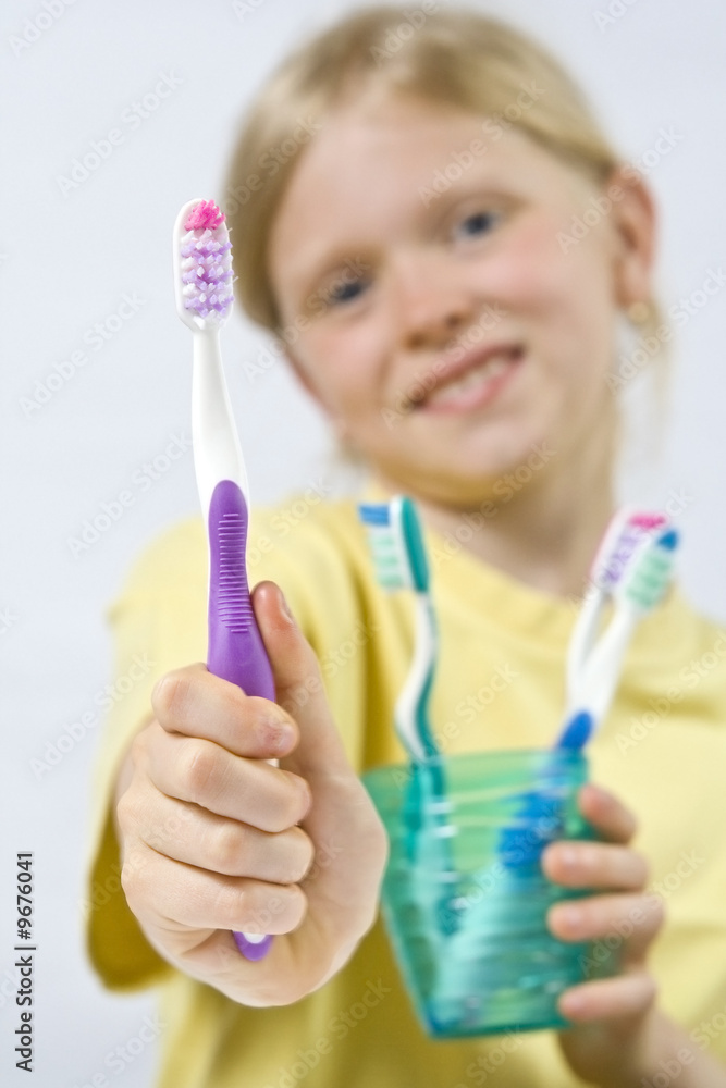 Little girl wearing colorful t-shirts brushing teeth Little girl wearing colorful t-shirts brushing teeth