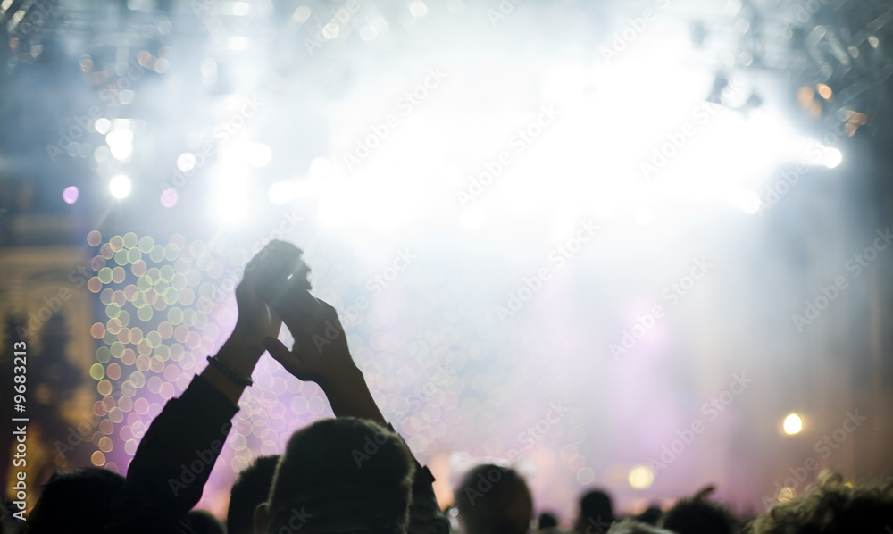 Man from behind watching concert and clapping hands Man from behind watching concert and clapping hands