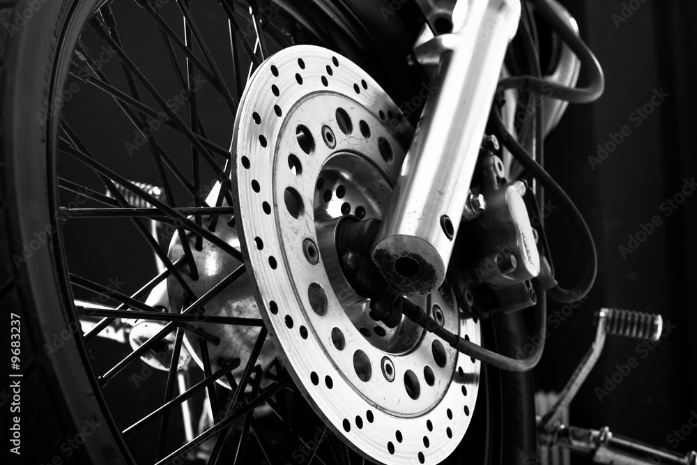 Obraz premium Closeup detail of a motorcycle front wheel - brake disc