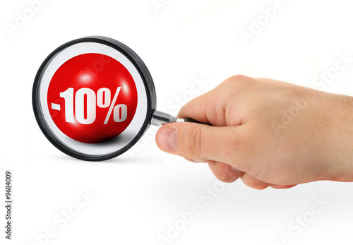 sale concept - hand with magnifying glass