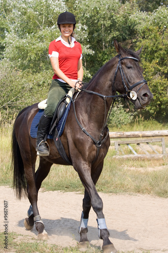 Smiling girl riding on horse