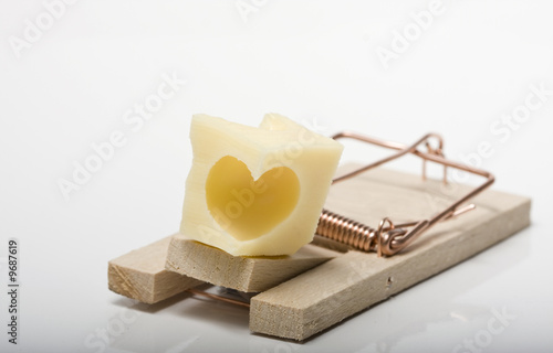 Lovetrap. Heart shaped cheese on mousetrap. Studio shot.