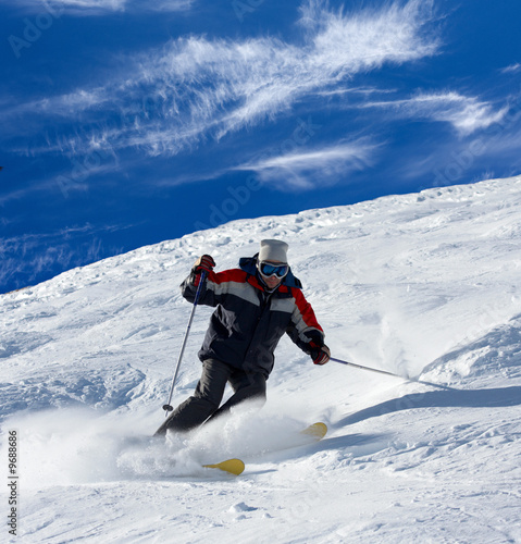 Skier rush with clouds of snow powder