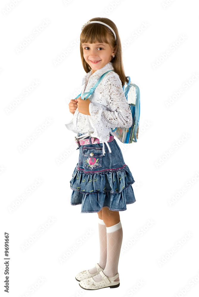 The little girl in a jeans skirt with a backpack The little girl in a jeans skirt with a backpack
