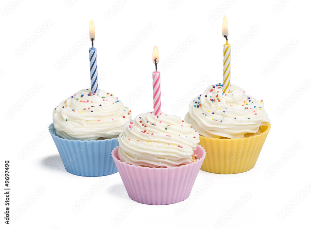 Three cupcakes with candle on white background Three cupcakes with candle on white background