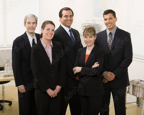 Group of co-workers posing in office
