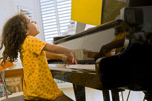 little girl playing the grand piano