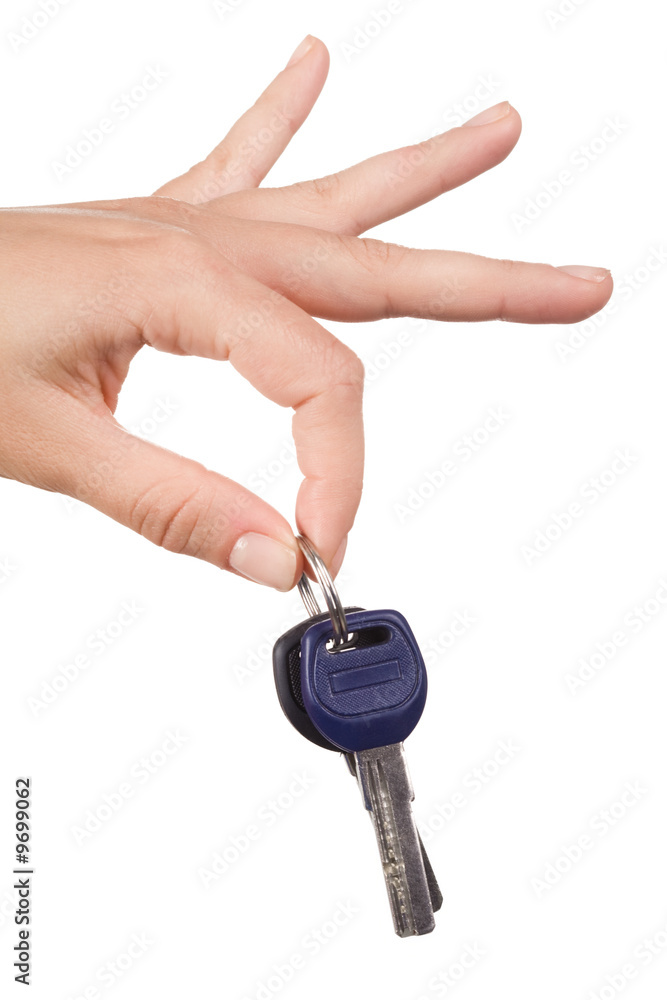 Close-up of keys held by forefinger and thumb Close-up of keys held by forefinger and thumb