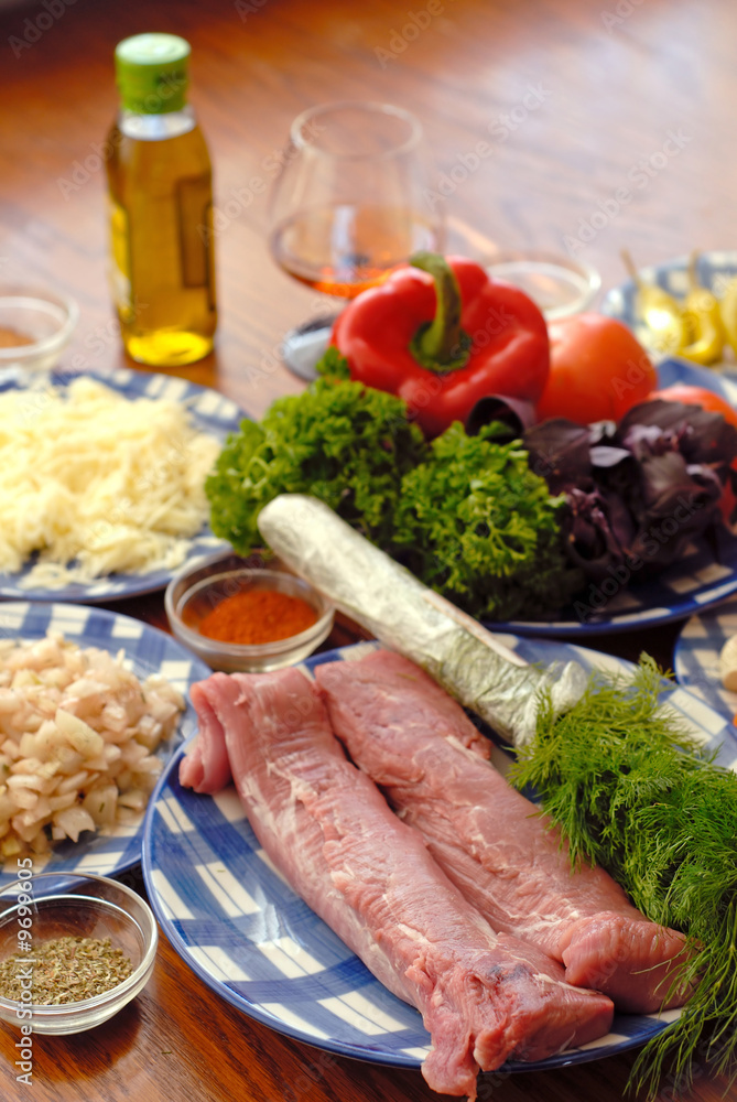 food components for preparation of dish in plates on  table