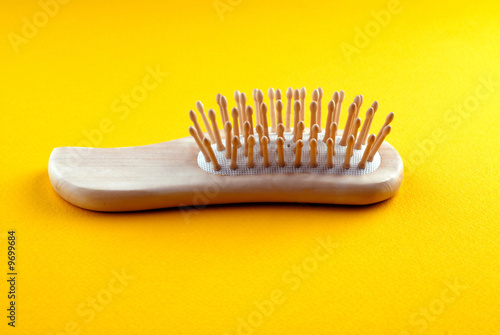 hairbrush on  yellow background