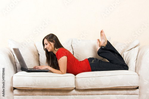 young woman on a lounge with laptop