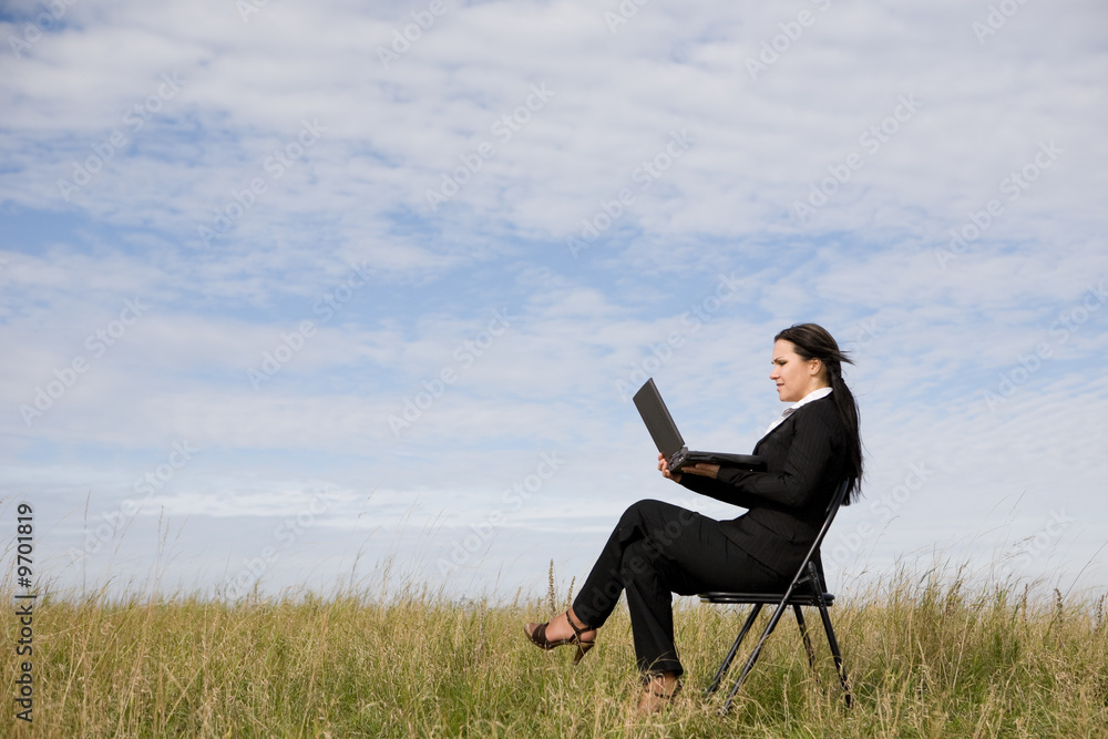 attractive brunette businesswoman relaxing on meadow attractive brunette businesswoman relaxing on meadow