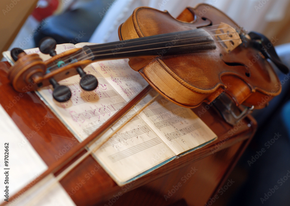 Fototapeta premium picture of wood violin on the table with notes