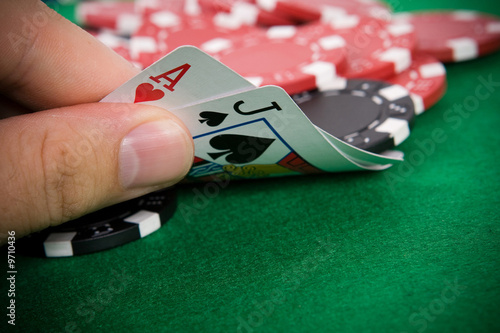 Ace of hearts and black jack with red poker chips