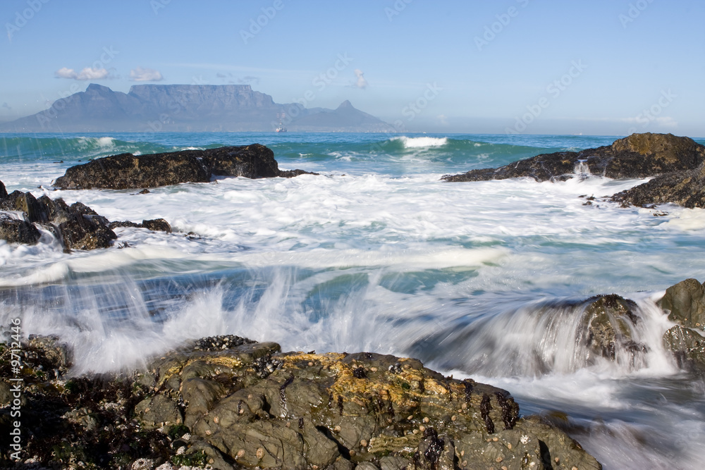 Table Mountain from Bloubergstrand with rocks in the foreground