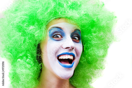 spooky female clown in heavy stage make-up
